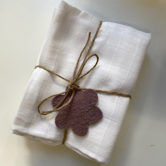 white muslin square three pack tied with a bow for gifting 